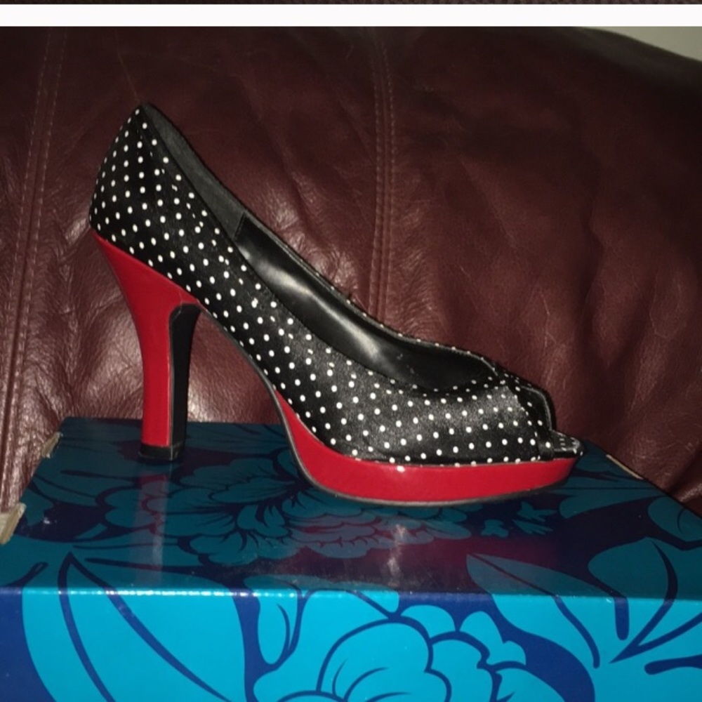 Gently worn black shoe with white polka dots